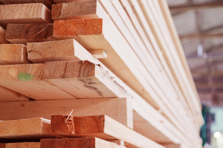 Warehouse or factory for sawing boards on sawmill indoors. Wood timber stack of wooden blanks...