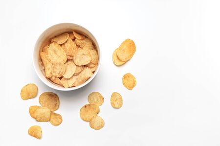 Potato chips and bowl on white background. Junk food concept. Top view. Flat lay.の写真素材