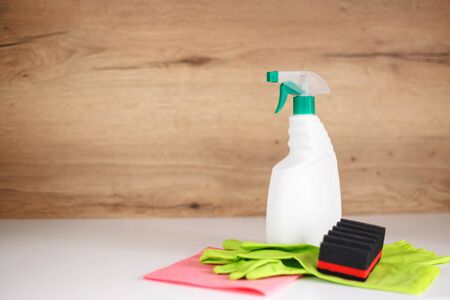 cleaning supplies: cleaning spray bottle with plastic dispenser, protective gloves, sponge.の写真素材
