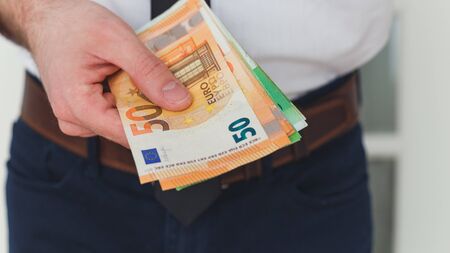 Detail of man hands with money, euro notesの写真素材