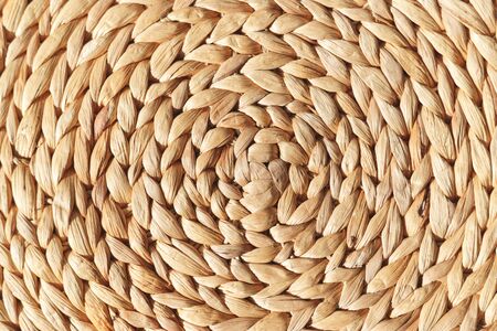 Wicker round placemat surface texture top view.の写真素材