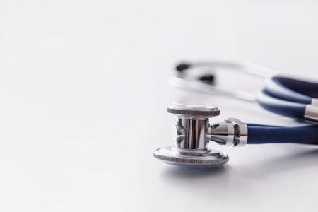 Medical stethoscope or phonendoscope on white table. Acoustic medical device for auscultation.