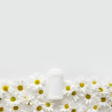 Flat lay composition with deodorant and flowers on white background with copy space.の写真素材