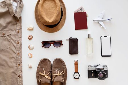 Male summer flat lay traveler accessories set isolated on white. Top view knolling.の写真素材