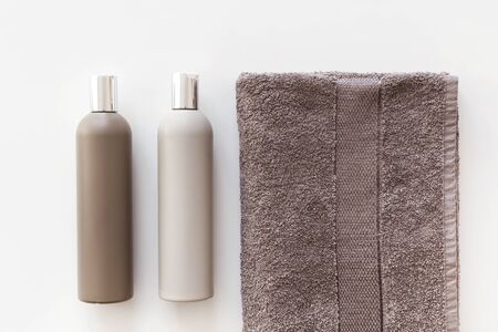 Plastic bottles of shampoo and body gel on towel isolated on white. Flat lay.の写真素材