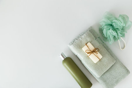 Bath towels with toiletries on white background. Flat lay, top view