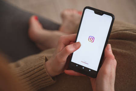 Minsk-Belarus: May 27, 2020: close up view on smartphone with instagram logo in womans hands. Social media concept.のeditorial素材