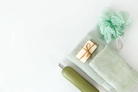 Bath towels with toiletries on white background. Flat lay, top viewの写真素材