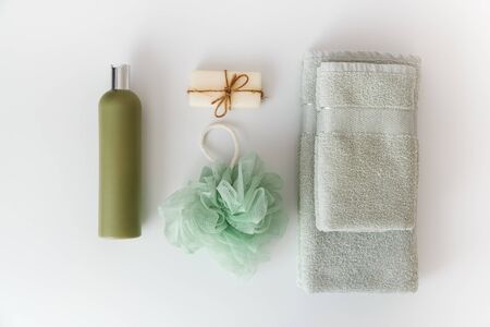 Bath towels with toiletries on white background. Flat lay, top viewの写真素材