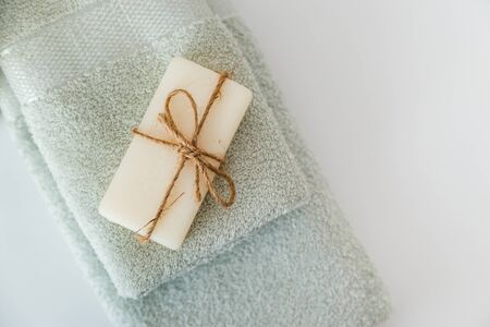 Solid soap corded on bath towels on white background with copy space. Top view with copy spaceの写真素材