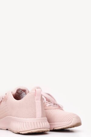 Pink female sneakers isolated on white background. Sport casual shoesの写真素材