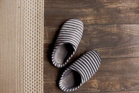 Slippers on the brown wooden floorの写真素材