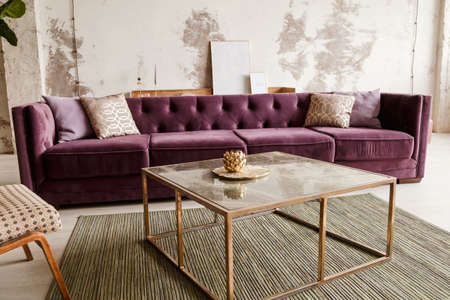 Purple velvet sofa with golden pillow in living room interiorの写真素材
