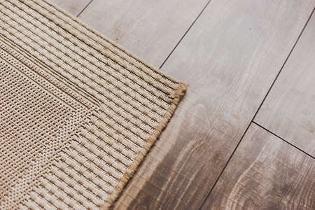 Laminate parquete floor with beige soft carpetの写真素材