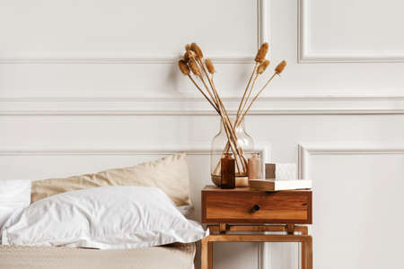 Cozy details in white contemporary bedroom interior with gypsum stucco on white wallsの写真素材