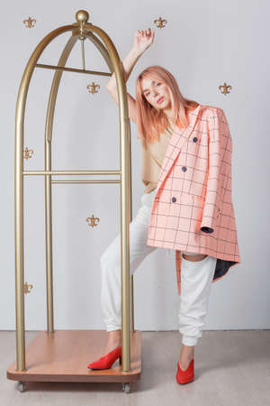 Fashion studio portrait of beautiful woman with amazing hair and beautiful face, wearing bright checkered jacketの写真素材