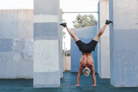 Man doing Handstand yoga pose outdoor.の写真素材