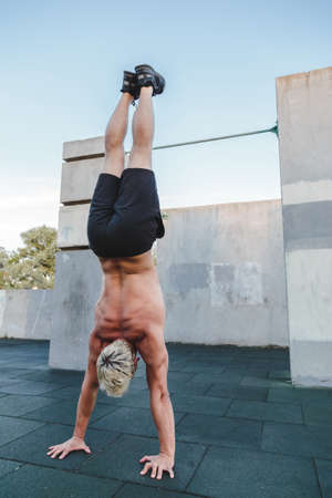 Man doing Handstand yoga pose outdoor.の写真素材