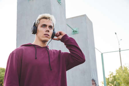 Young sports man with headphones outdoor.の写真素材