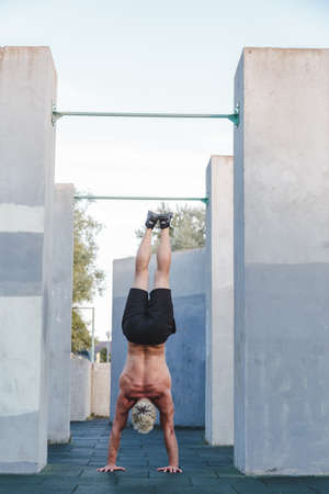 Man doing Handstand yoga pose outdoors.の写真素材