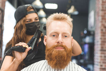 Portrait of a customer with a female hairdresser in a salonの写真素材