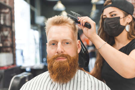 Portrait of a customer with a female hairdresser in a salonの写真素材
