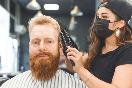 Portrait of a customer with a female hairdresser in a salonの写真素材
