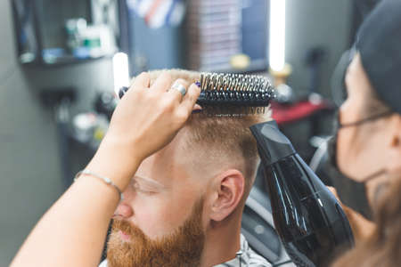 Portrait of a customer with a female hairdresser in a salonの写真素材