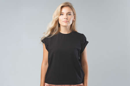 Blonde beautiful woman in black T-Shirt. Studio shootの写真素材