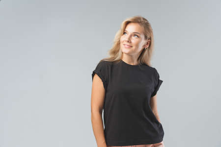 Blonde beautiful woman in black T-Shirt. Studio shootの写真素材