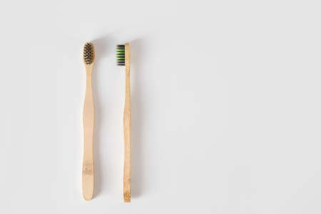 Two wooden bamboo toothbrushes on white with copy space. Zero waste. concept. Flat lay. Hygiene suppliesの写真素材