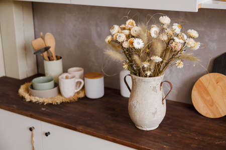 kettle kitchen corner decoration and yellow tulips with bibの写真素材