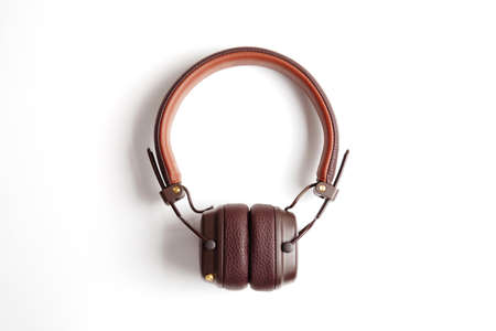 Modern brown leather wireless headphones isolated on whiteの写真素材