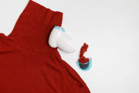 Device for removing lint from wool clothes. Golf with fuzz ball isolated on white background.の写真素材