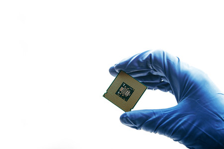 Close-up view on a new semiconductor microchip in gloved hand of computer scientist. Modern technology and hardware developmentの写真素材