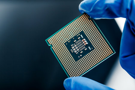 Close-up view on a new semiconductor microchip in gloved hand of computer scientist. Modern technology and hardware developmentの写真素材