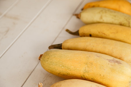 Yellow squashes on a wooden tableの写真素材