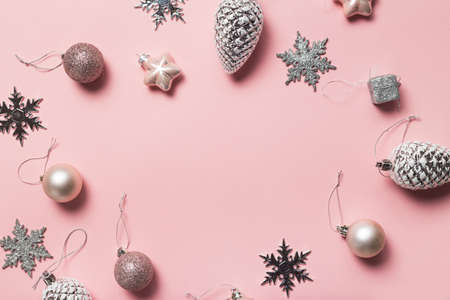 Christmas greeting card. Gift boxes and Christmas decorations layout on pink background, top view. Flat layの写真素材