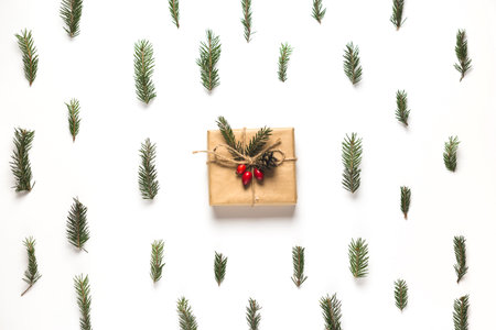 Christmas composition. Frame made of christmas gifts, pine branches, on white background. Flat lay,...