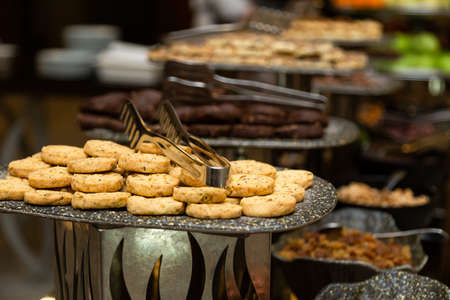 Buffet table with various cookies and biscuits, tarts and cakesの写真素材