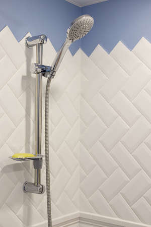 Modern shower on wall rail in modern white bathroomの写真素材