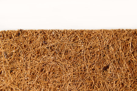 Close-up mattress made of coconut fiber isolated over white.の写真素材