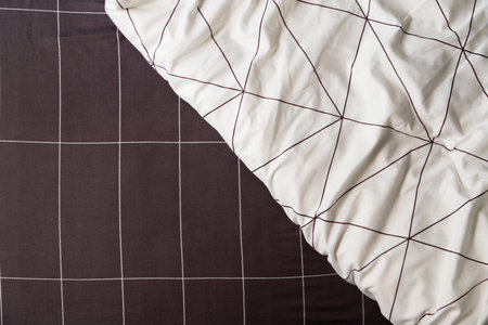 Elegant linen plaid sheet and white blanket with geometric design