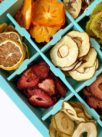 Box with dried fruits chips isolated on white, top view.の写真素材