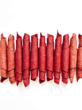 Red fruit leather rolls isolated on white. Fruit candy - pastille. top viewの写真素材