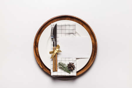 Christmas and new year invitation to dinner party on dish with christmas decoration. Flat lay winter holidays concept. celebration card. isolated on redの写真素材