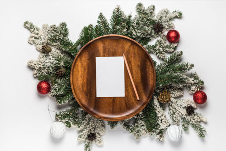 Envelope with blank card on wooden plate and christmas tree branches. Flat lay christmas and new...
