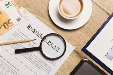 Flat lay of business plan on office workplace, top view.の写真素材