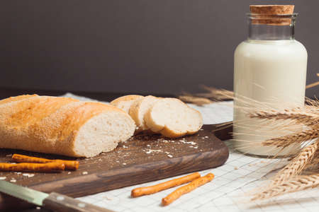 Ciabatta bread with milk bottle and ears of wheat.の写真素材