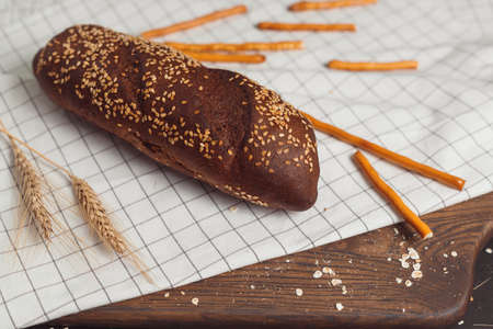 Sliced rye bread on cutting board. Whole grain rye bread with seeds.の写真素材